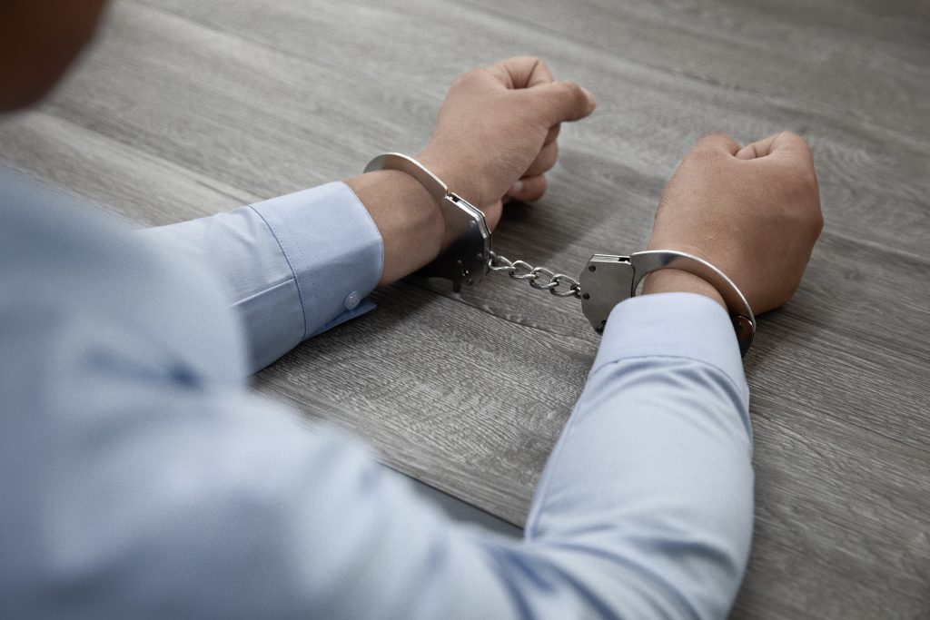 Shot of male hands in handcuffs